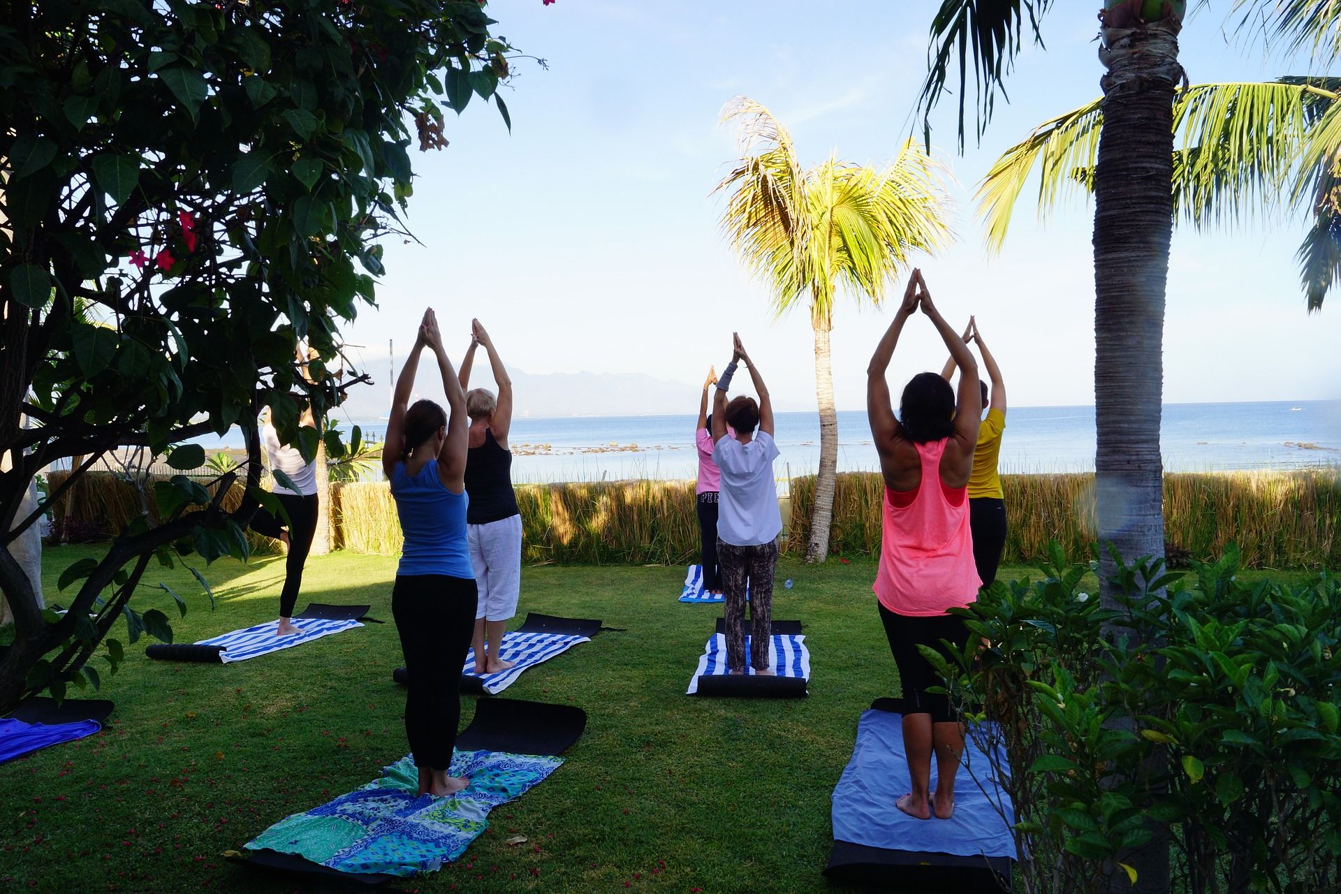 outdoor yoga class with ocean background